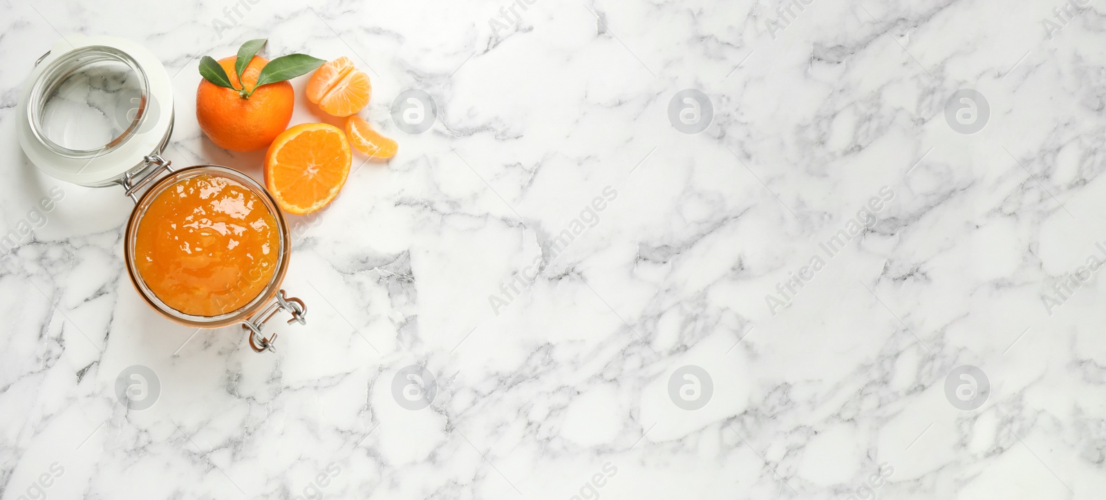 Image of Flat lay composition with tasty tangerine jam on white marble table, space for text. Banner design