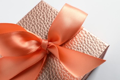 Photo of Beautiful pink gift box with bow on white background, closeup