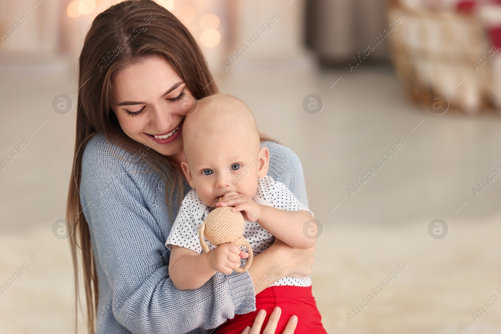 Photo of Happy mother with cute baby at home. Celebrating Christmas