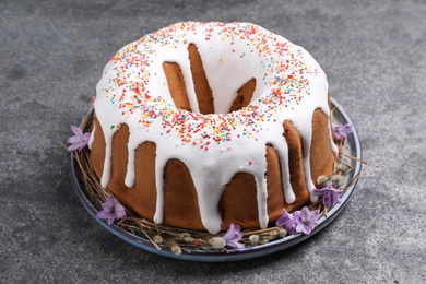 Glazed Easter cake with sprinkles on grey table