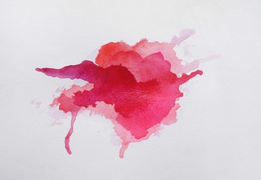 Magenta watercolor blot on white background, top view