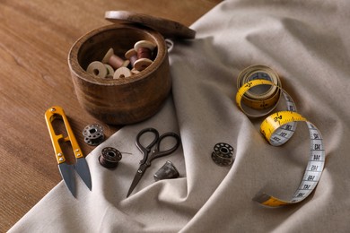 Set of sewing supplies and accessories on wooden table