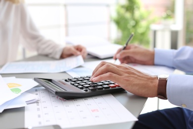 Tax accountants working with documents at table