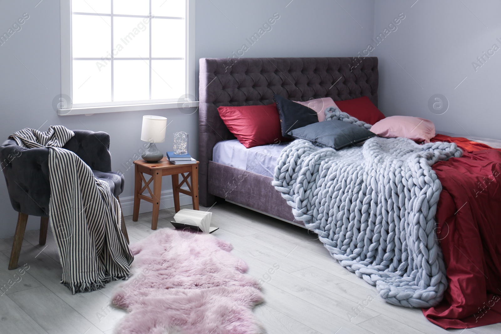 Photo of Interior of light modern room with comfortable bed