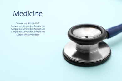 Stethoscope on light blue background, closeup. Space for text