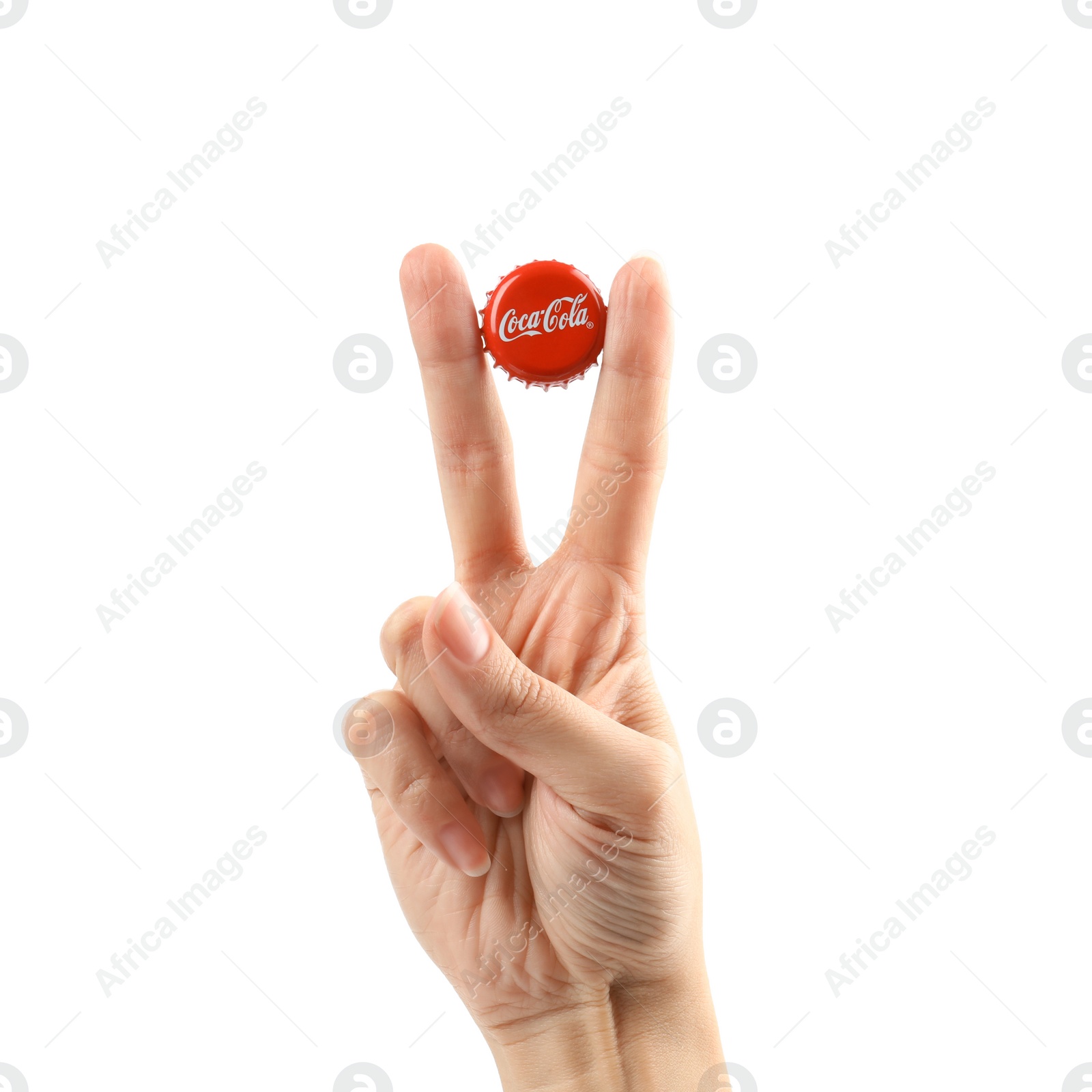 Photo of MYKOLAIV, UKRAINE - NOVEMBER 15, 2018: Woman holding Coca Cola lid on white background