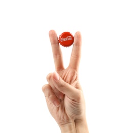 MYKOLAIV, UKRAINE - NOVEMBER 15, 2018: Woman holding Coca Cola lid on white background