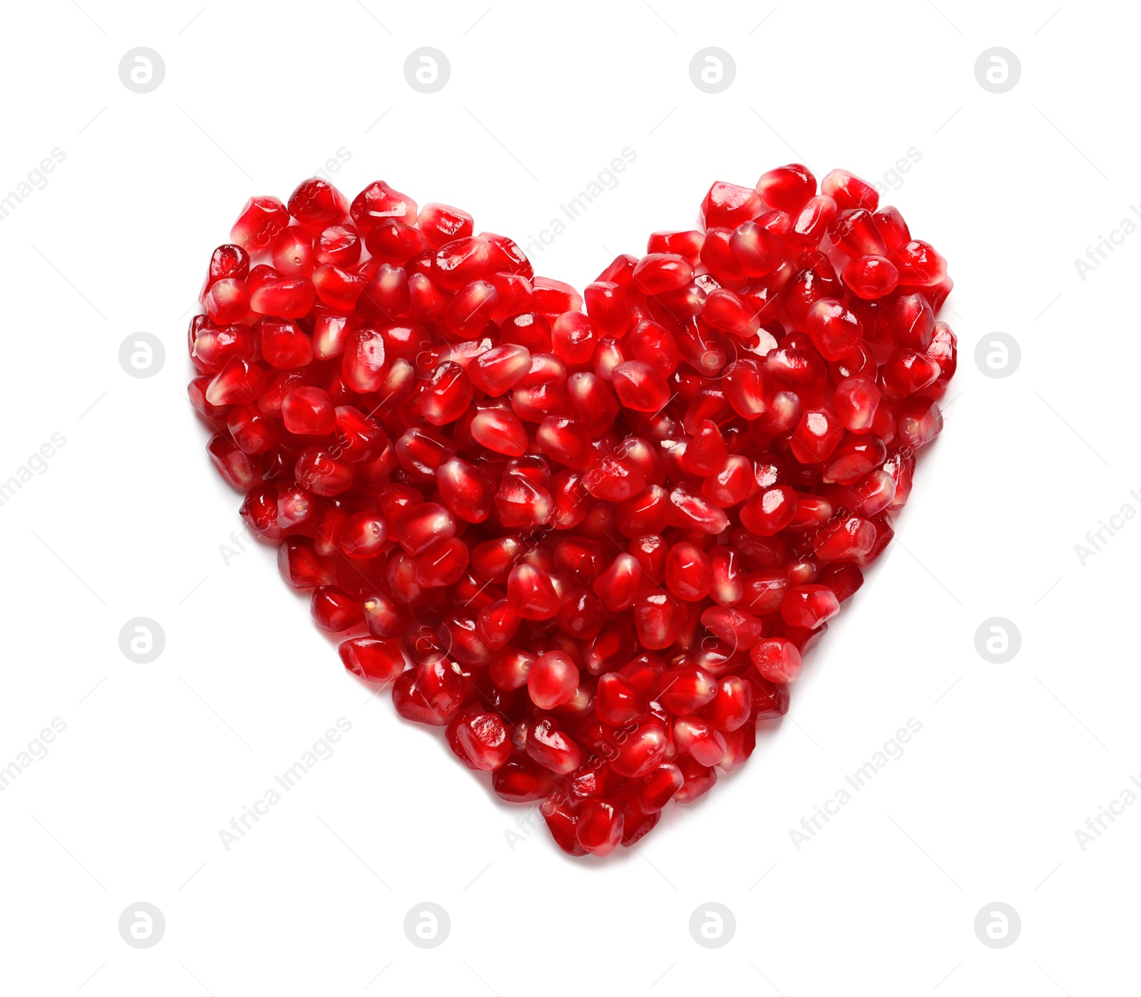 Photo of Heart made of pomegranate seeds on white background, top view. Healthy diet