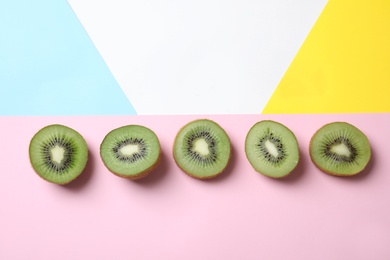 Top view of sliced fresh kiwis on color background