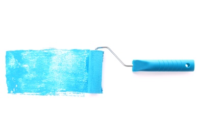 Photo of Roller brush with blue paint on white background, top view