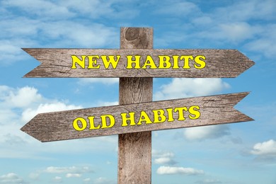 Image of Signpost with two opposite directions to Old and New Habits outdoors