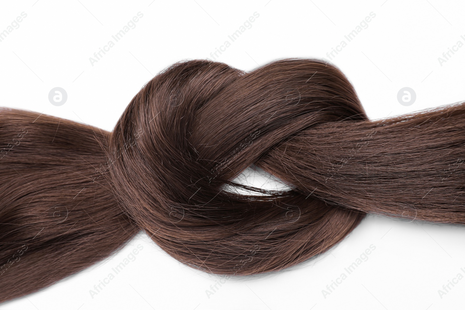 Photo of Beautiful strand of dark brown hair tied in knot on white background, top view