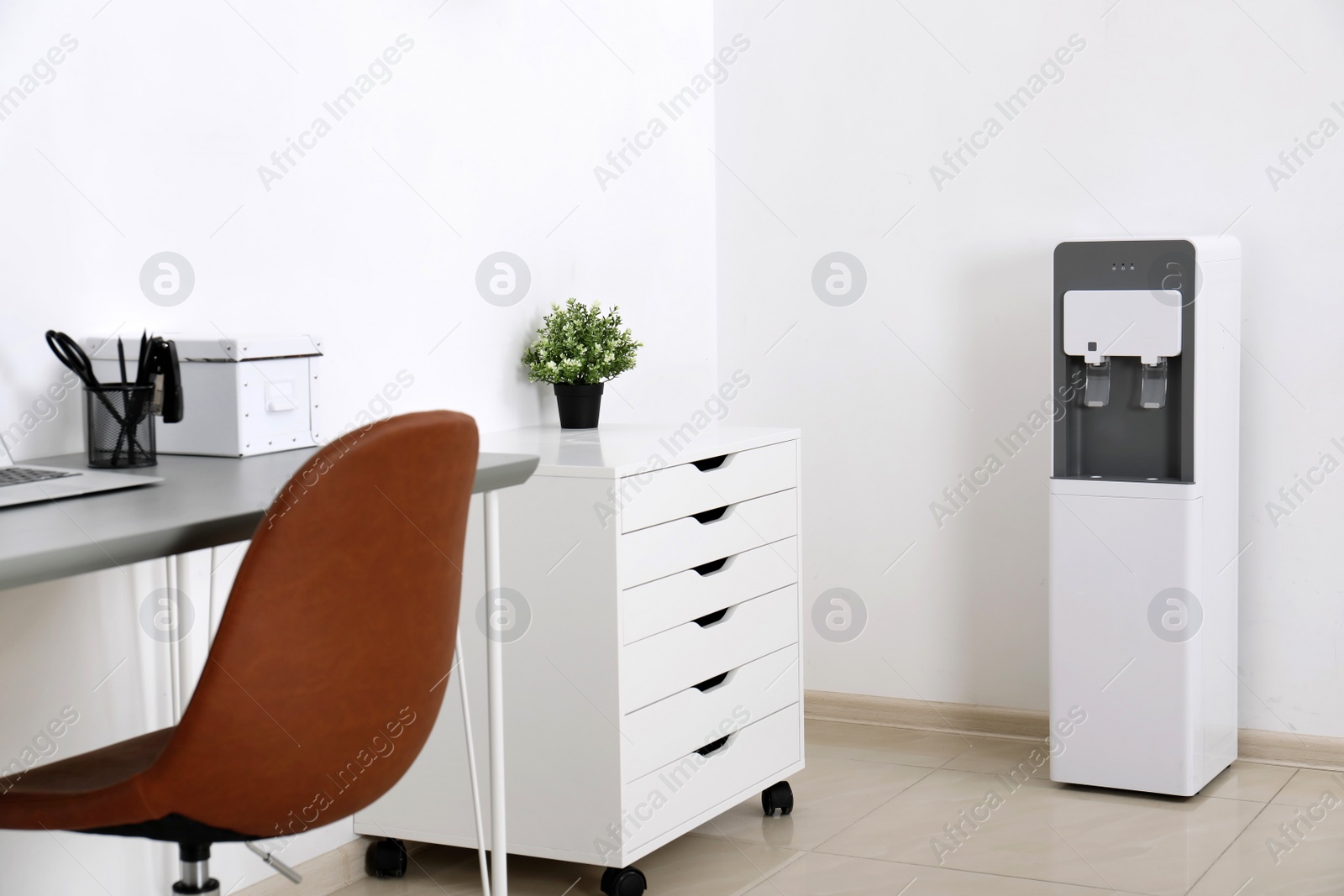 Photo of Modern water cooler in stylish office interior