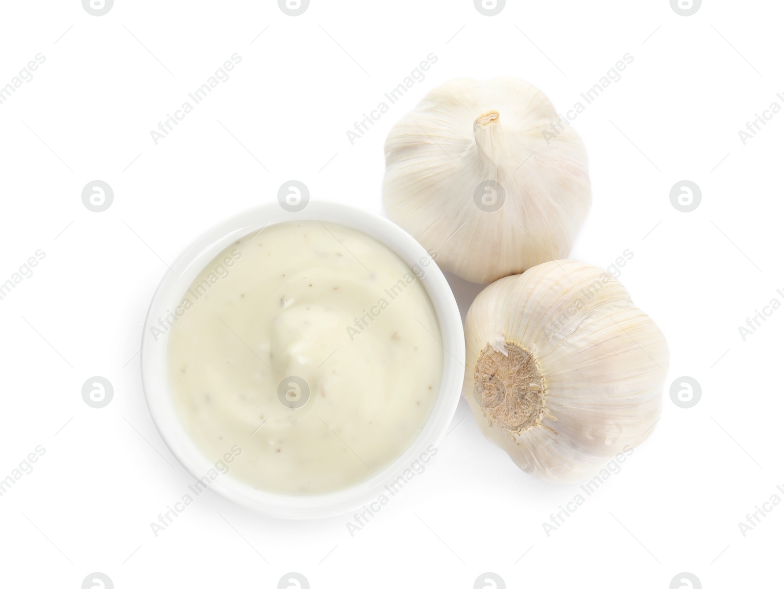 Photo of Bowl of homemade sauce and garlic isolated on white, top view