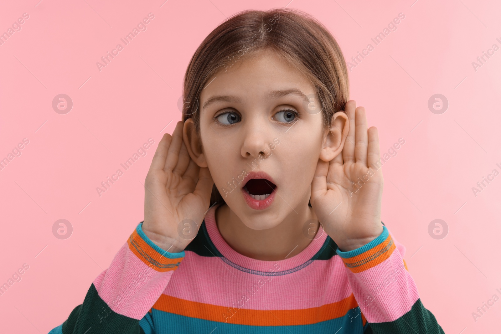 Photo of Little girl with hearing problem on pink background