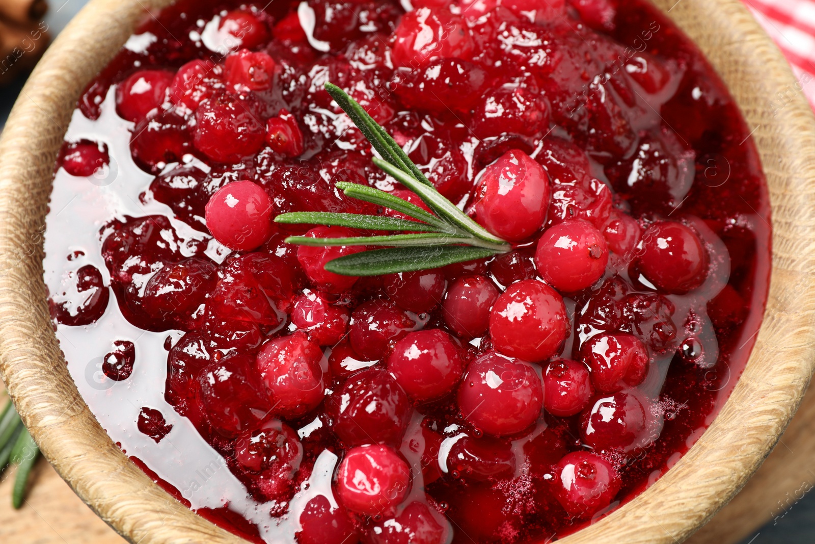 Photo of Delicious fresh cranberry sauce with rosemary, closeup