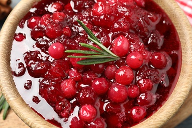 Photo of Delicious fresh cranberry sauce with rosemary, closeup