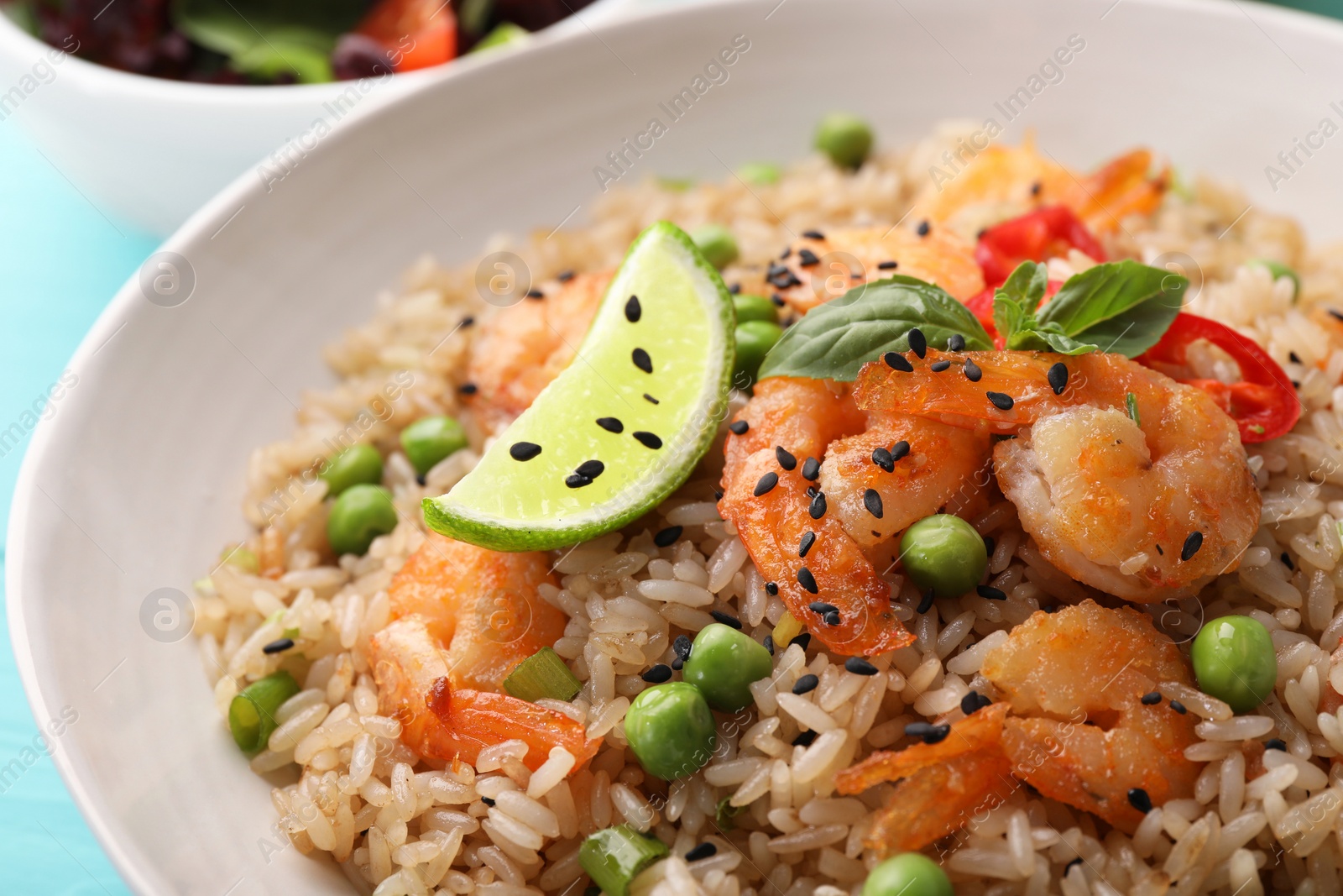 Photo of Tasty rice with shrimps and vegetables in bowl, closeup