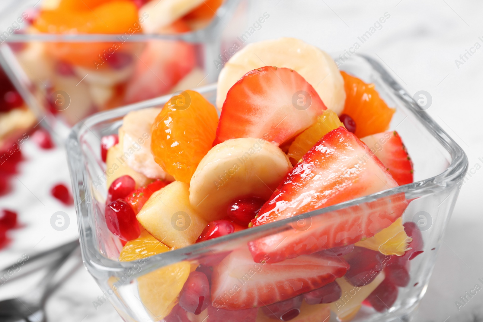 Photo of Delicious fresh fruit salad in bowl on table, closeup view