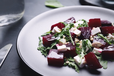 Delicious beet salad served on black table, closeup