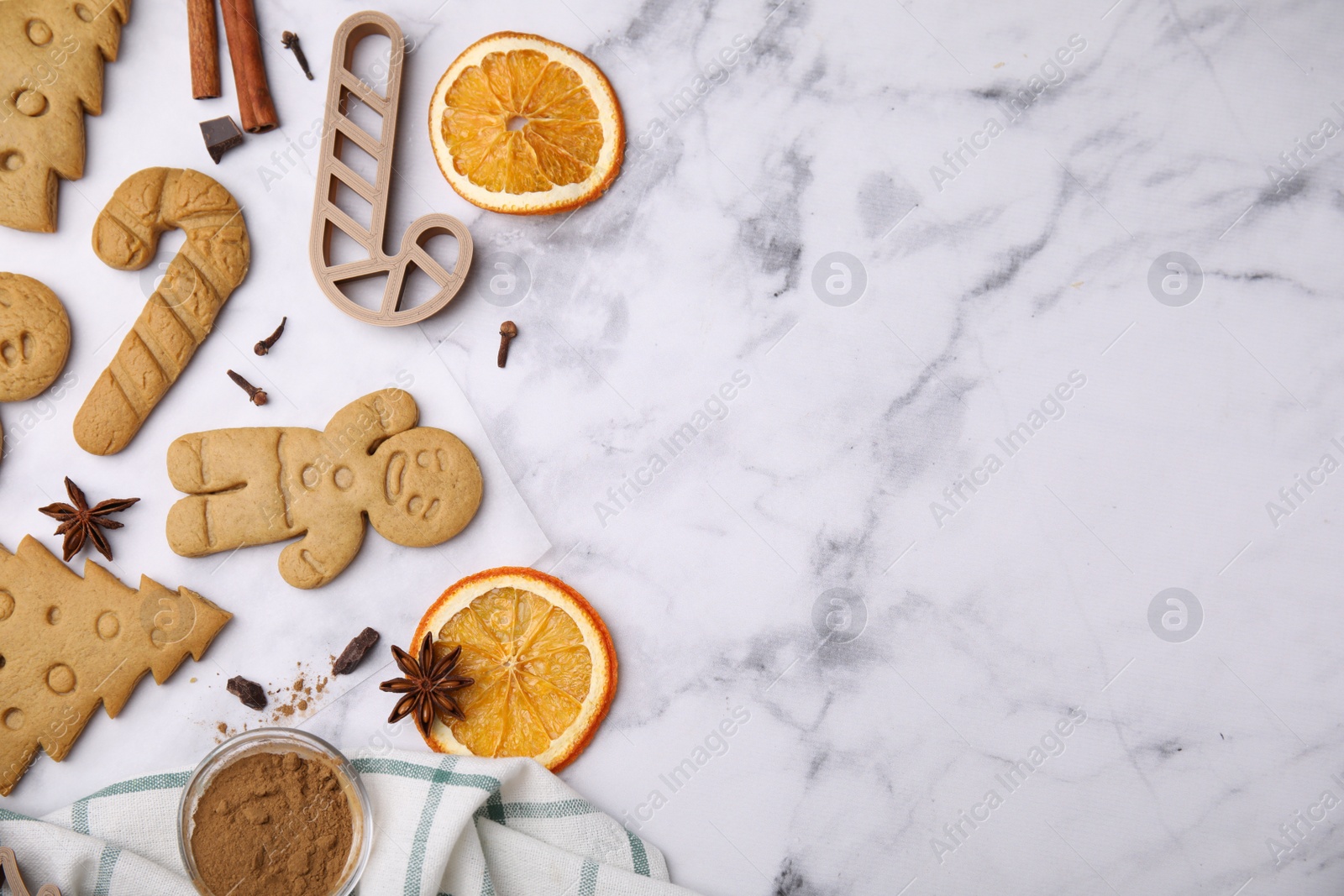 Photo of Flat lay composition with tasty cookies, spices and cutter on white marble table, space for text