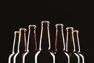 Photo of Many bottles of beer on dark background