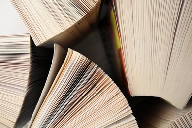 Photo of Collection of different books on white shelf, above view