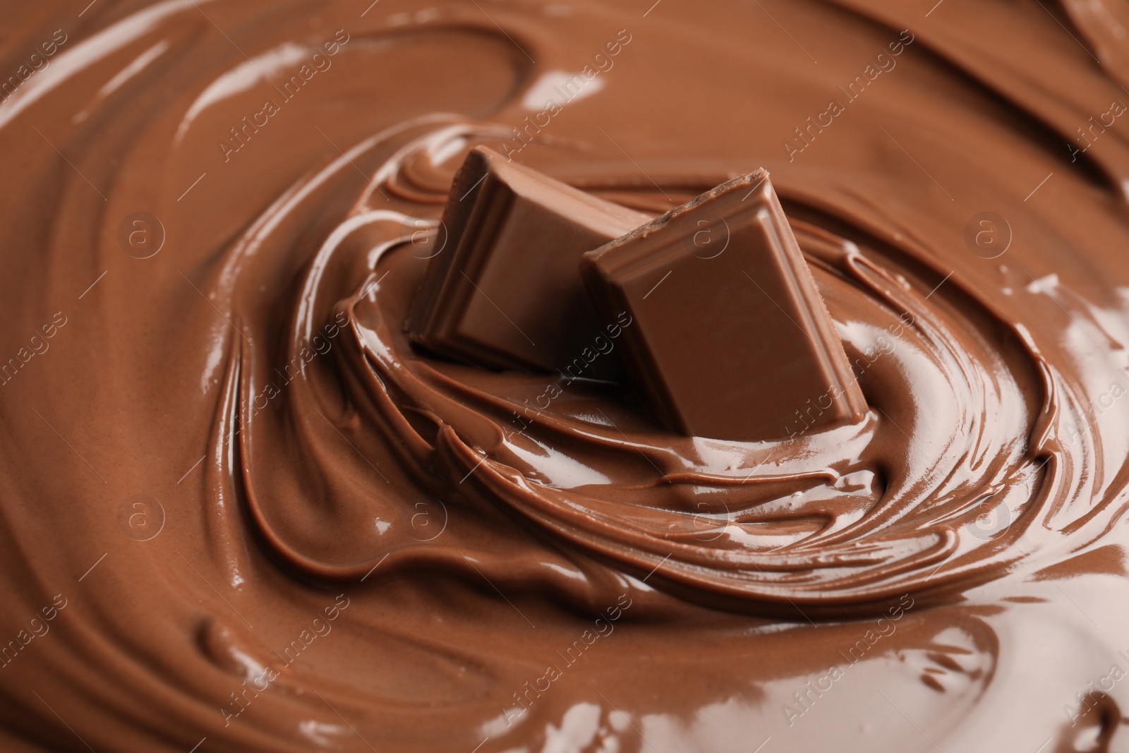 Photo of Sweet tasty chocolate cream with pieces as background, closeup