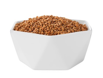 Photo of Uncooked buckwheat in bowl isolated on white