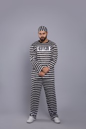 Photo of Prisoner in special uniform on grey background