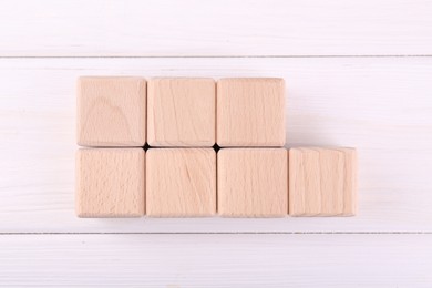 Photo of International Organization for Standardization. Cubes with abbreviation ISO and number 9001 on white wooden table, flat lay