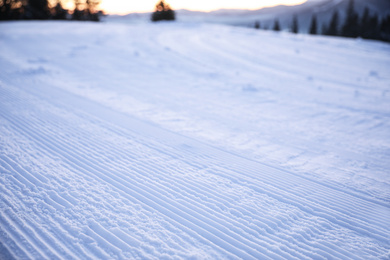 Photo of Empty road covered with snow on winter day