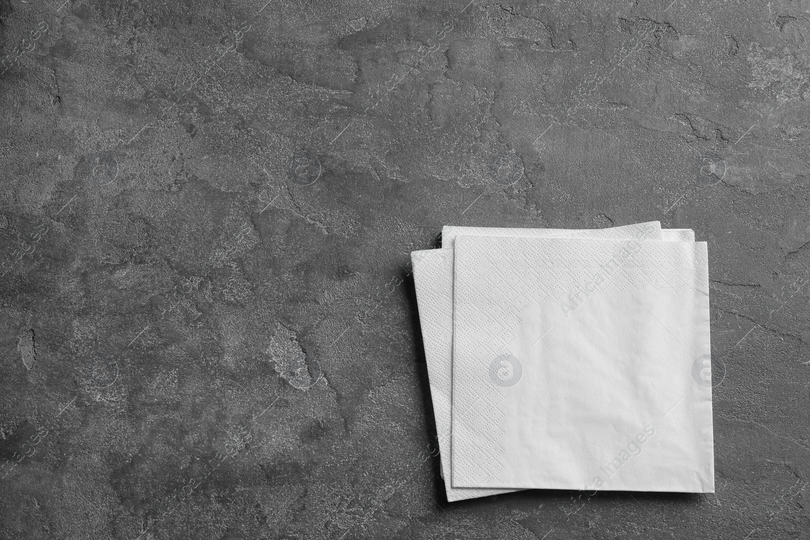 Photo of Clean napkins on grey background, top view with space for text