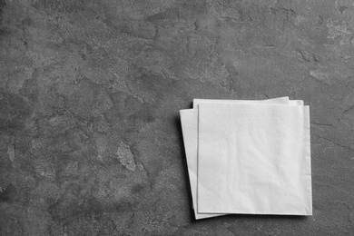 Photo of Clean napkins on grey background, top view with space for text