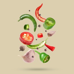 Image of Different spices falling on dark beige background