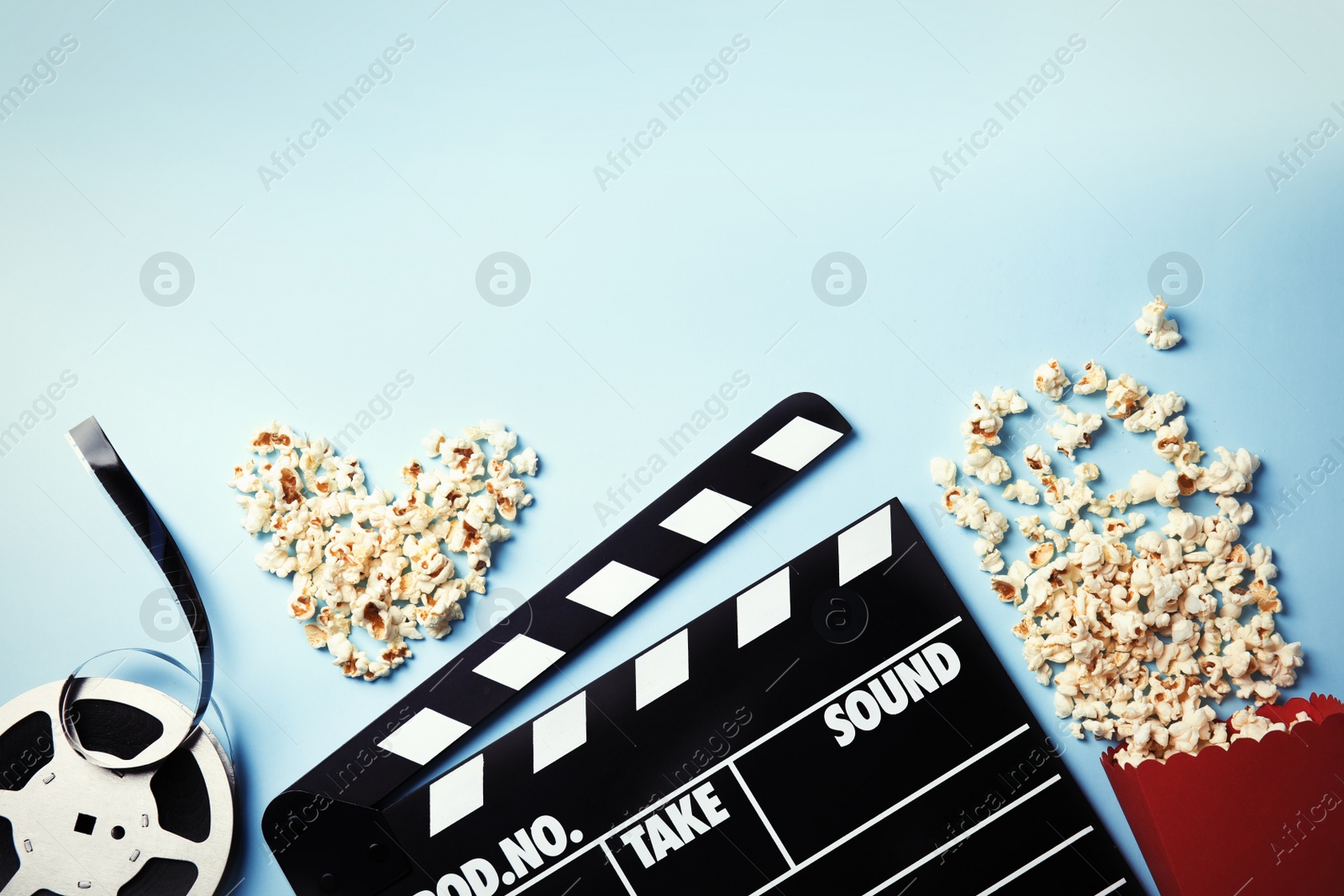 Photo of Flat lay composition with popcorn and space for text on color background. Cinema snack