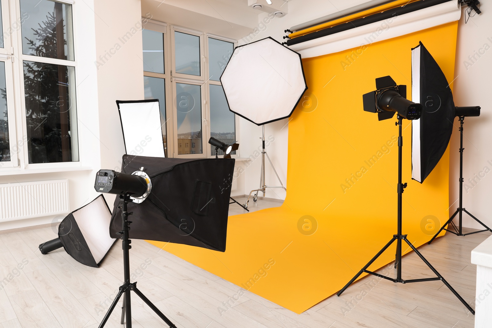 Photo of Interior of modern photo studio with professional lighting equipment