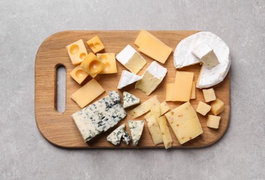 Cheese plate on light grey table, top view