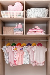 Photo of Wardrobe with cute baby clothes and home stuff