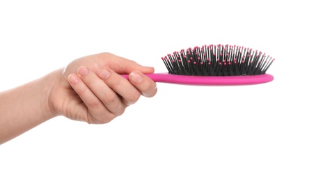 Photo of Woman holding hair brush on white background, closeup