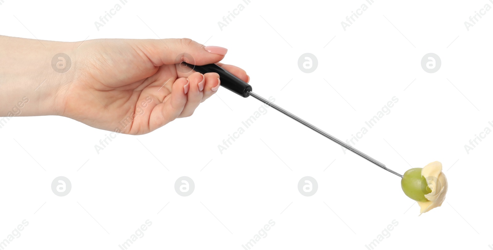 Photo of Tasty fondue. Woman holding fork with grape and melted cheese on white background, closeup