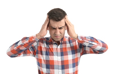 Young man suffering from headache on white background