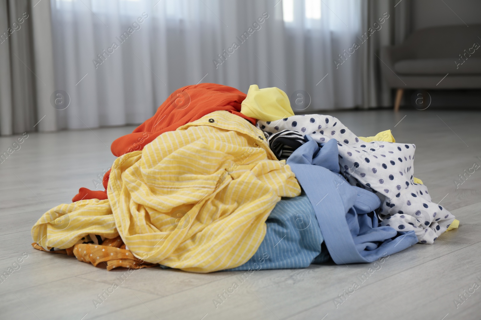 Photo of Pile of dirty clothes on floor indoors