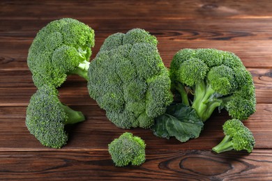 Photo of Fresh raw green broccoli on wooden table