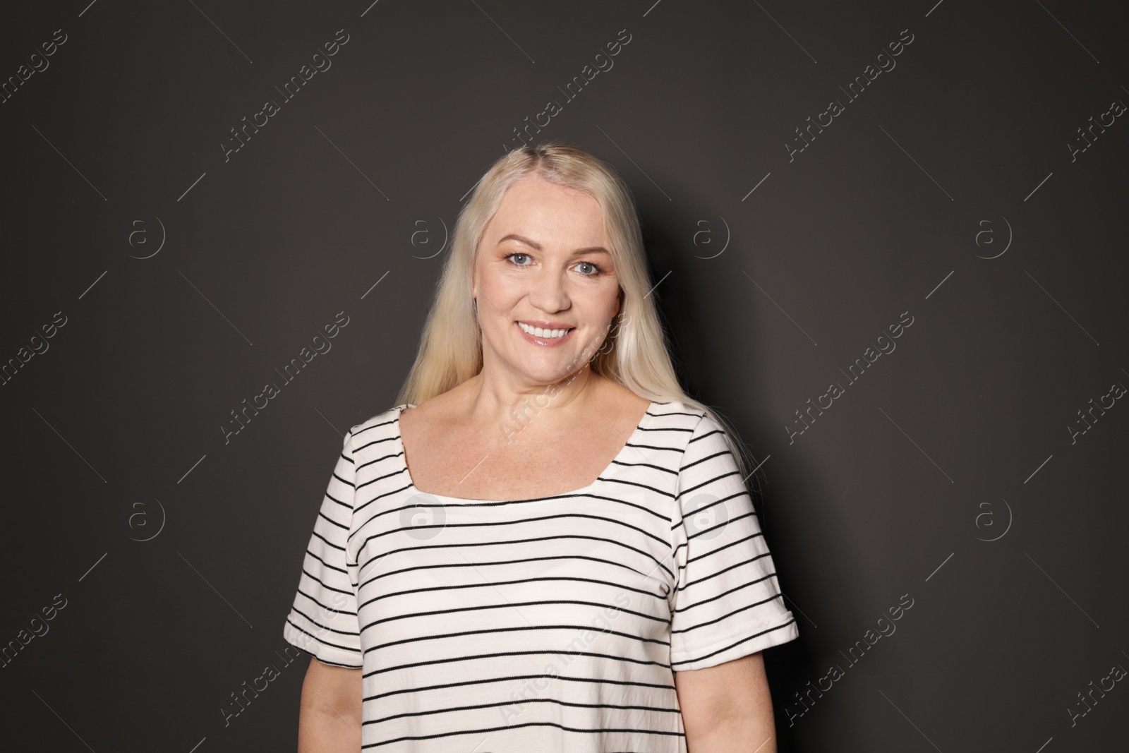 Photo of Portrait of mature woman on black background