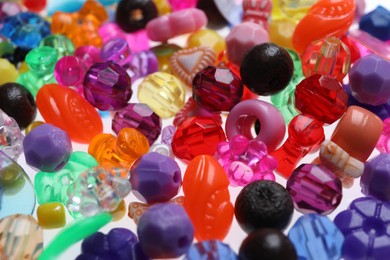Photo of Pile of bright colorful beads as background, closeup