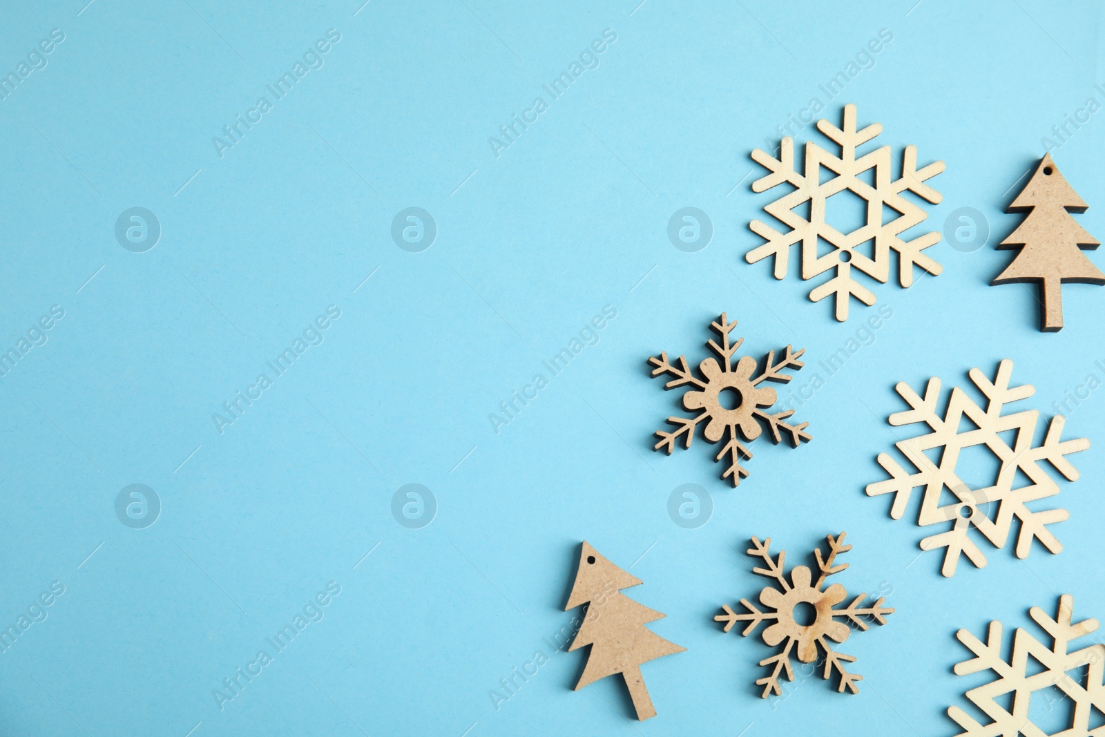 Photo of Flat lay composition with Christmas decor on blue background. Space for text