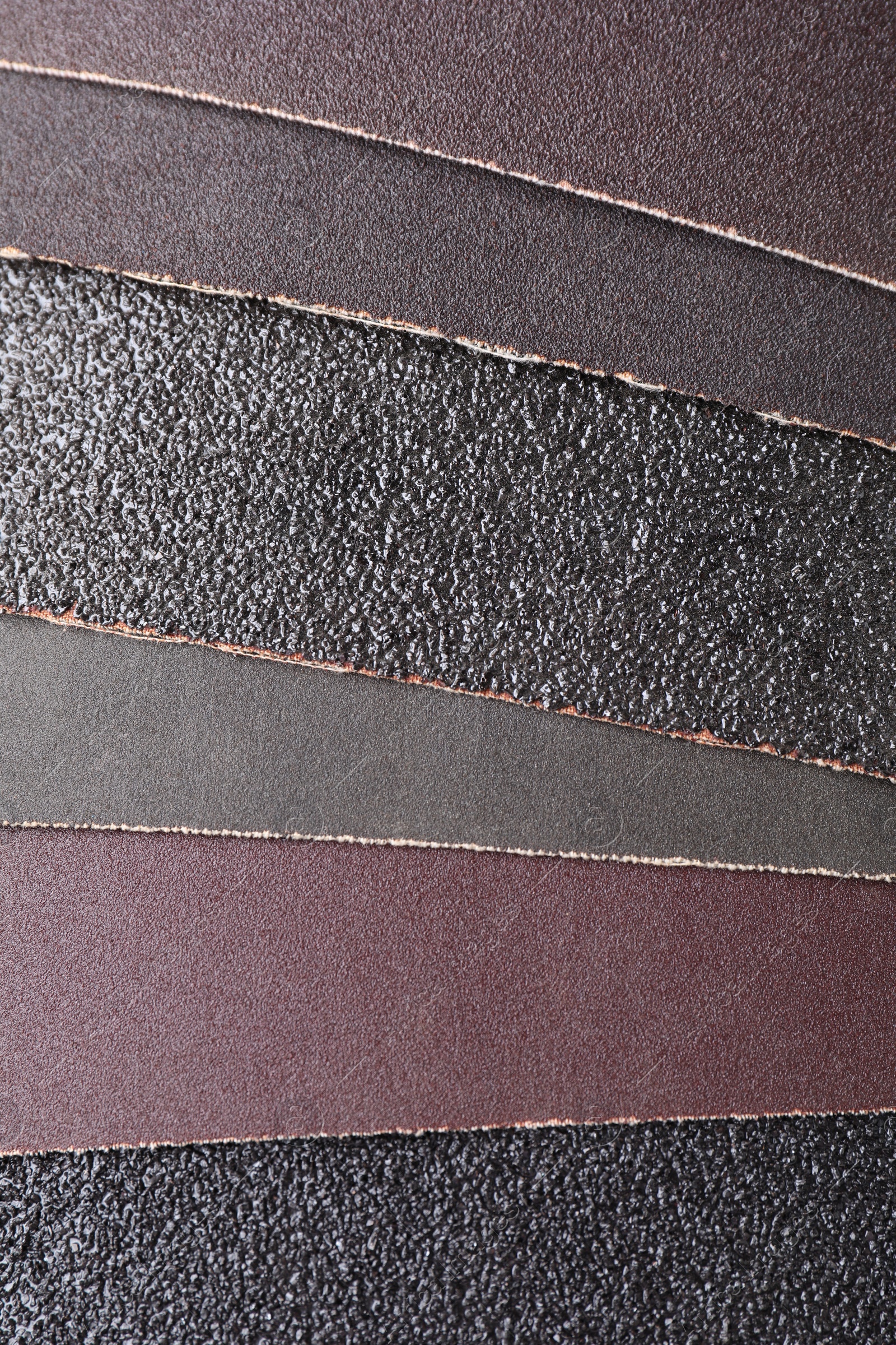 Photo of Many sheets of sandpaper as background, top view