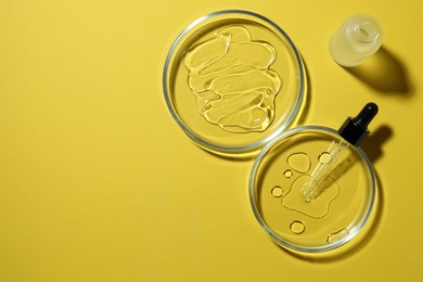 Photo of Flat lay composition with Petri dishes on yellow background. Space for text