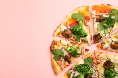 Photo of Delicious vegetarian pizza on pink table, top view. Space for text